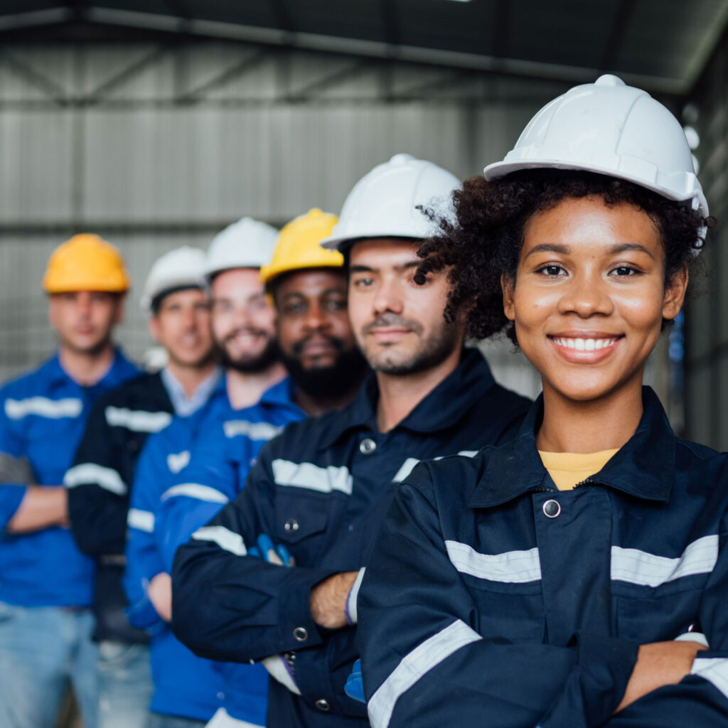 A maintenance team and production team stand together in a manufacturing factory